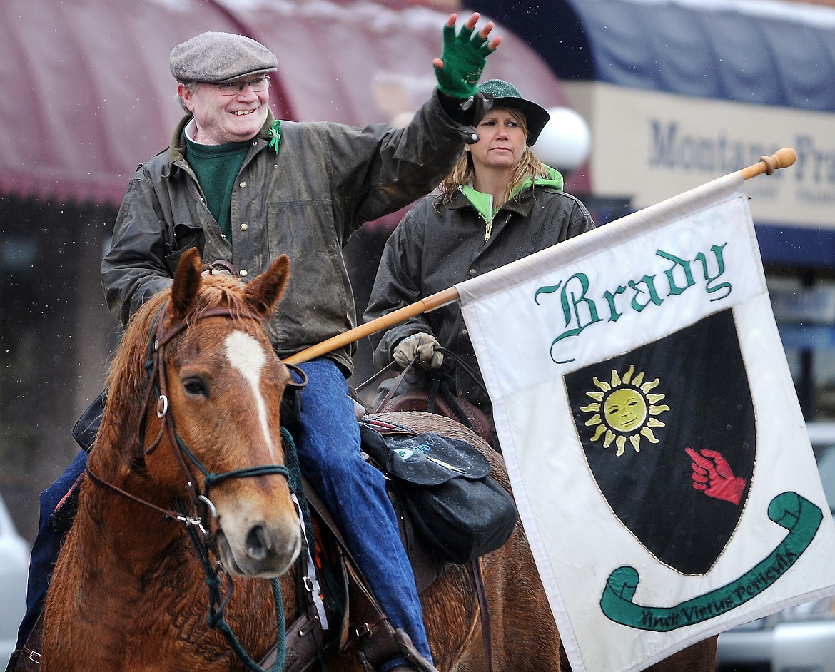 Dick Brady of the Ancient Order of the Hibernians waves to the people to lined Main Street for the annual Saint Patrick&#146;s Day parade in 2012 in downtown Kalispell. (Brenda Ahearn/Daily Inter Lake file)