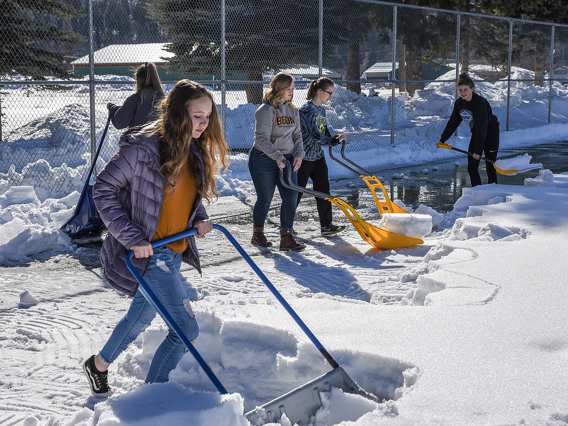 The Libby High School tennis team was hard at work clearing the courts of snow Friday. Pictured, left to right, are Laneigha Zeiler, alumni volunteer Laurynn Lauer, Ciera Lucas and Elise Erickson. Gabby Fantozzi is in the background dumping snow. (Ben Kibbey/The Western News)
