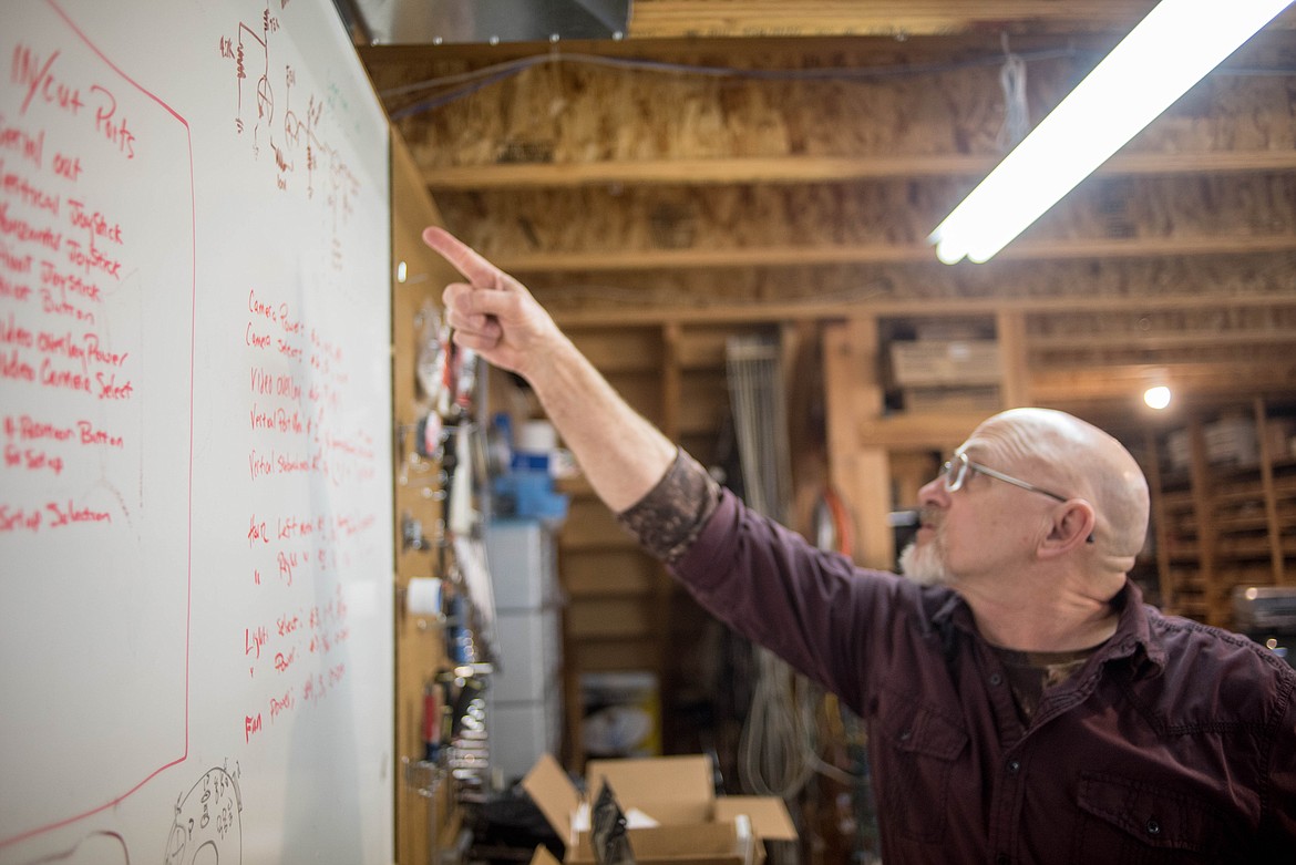 Bob Hosea points at electrical notes on the wall of his workspace, March 12 in Libby. (Luke Hollister/The Western News)