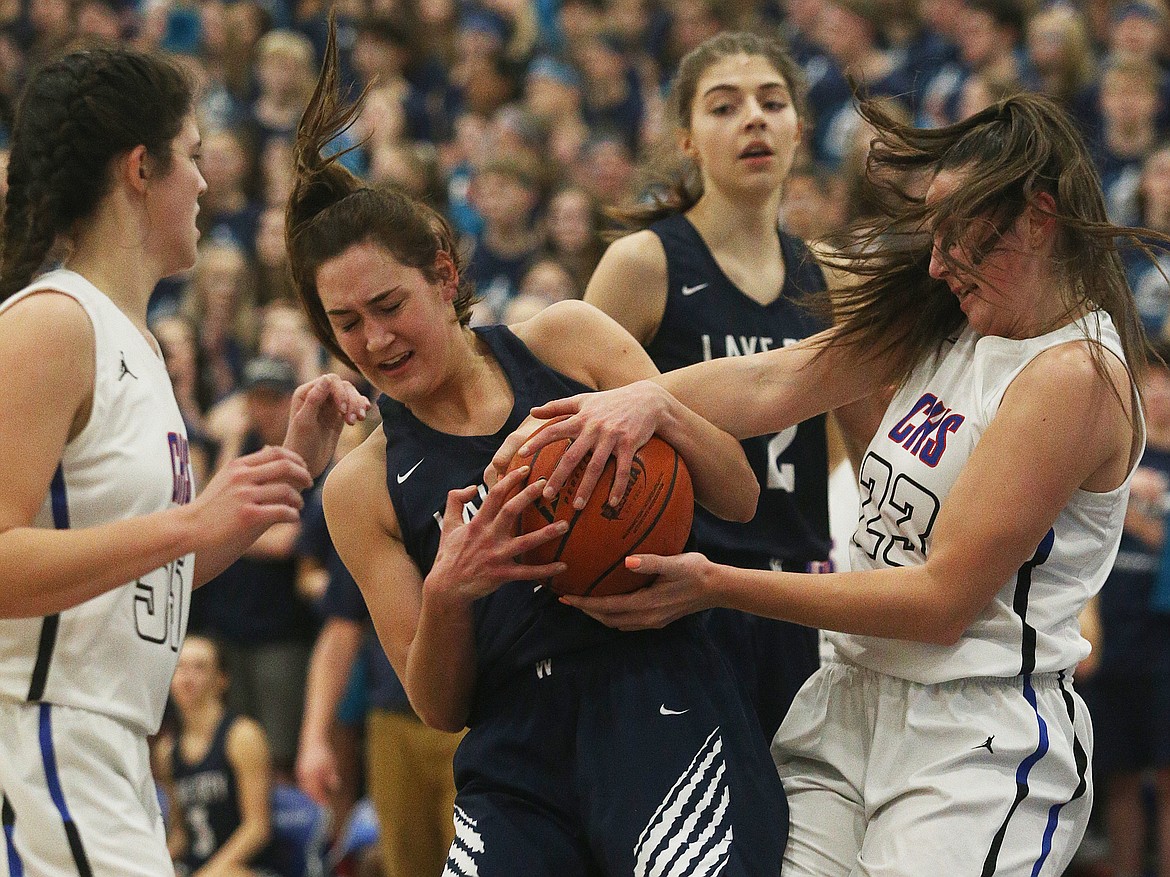 Lake City&#146;s Bridget Rieken, center, and Coeur d&#146;Alene&#146;s Kelly Horning fight for a rebound.