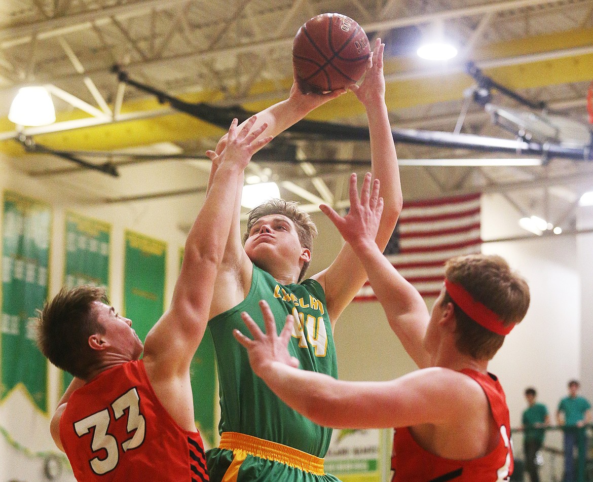 Lakeland&#146;s Josiah Haaland goes for a layup while defended by Sandpoint&#146;s Brandon Casey, left, and Will Treadaway during Battle for the Paddle.