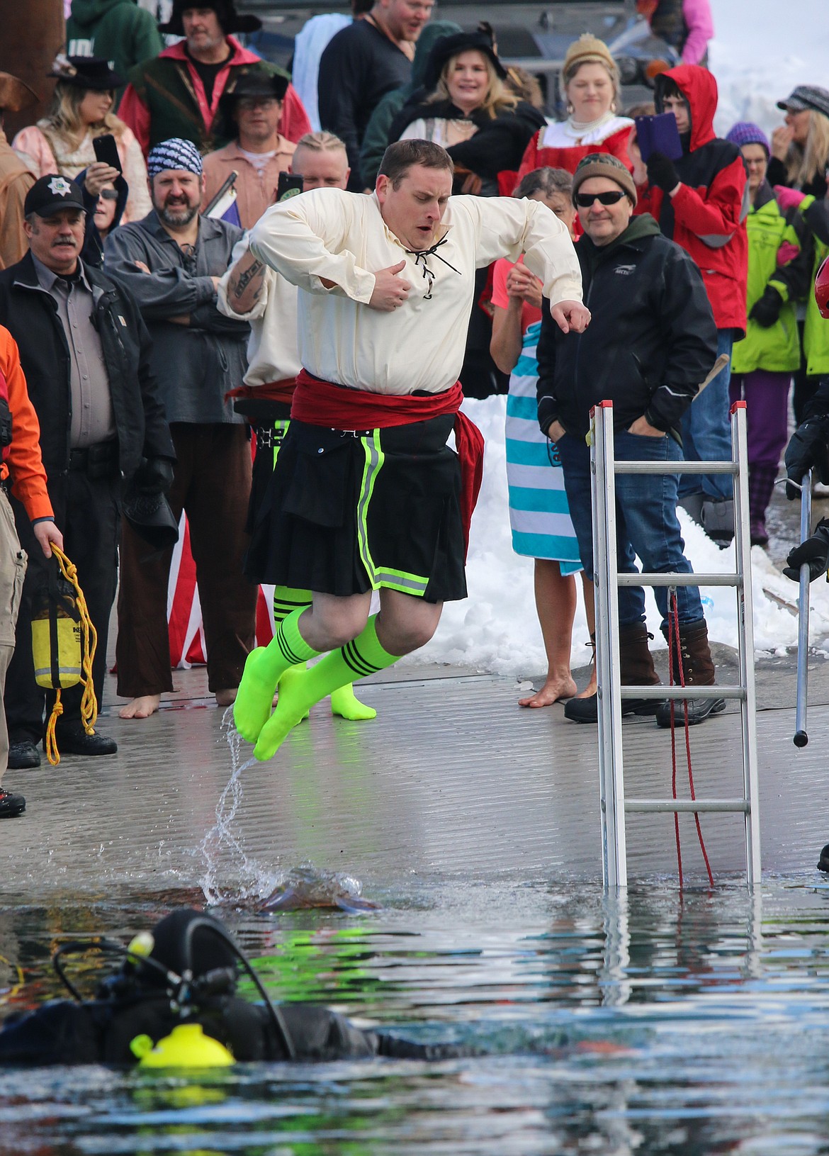 Photo by MANDI BATEMAN
North Bench Fire Chief Gus Jackson takes a mighty leap off the dock.