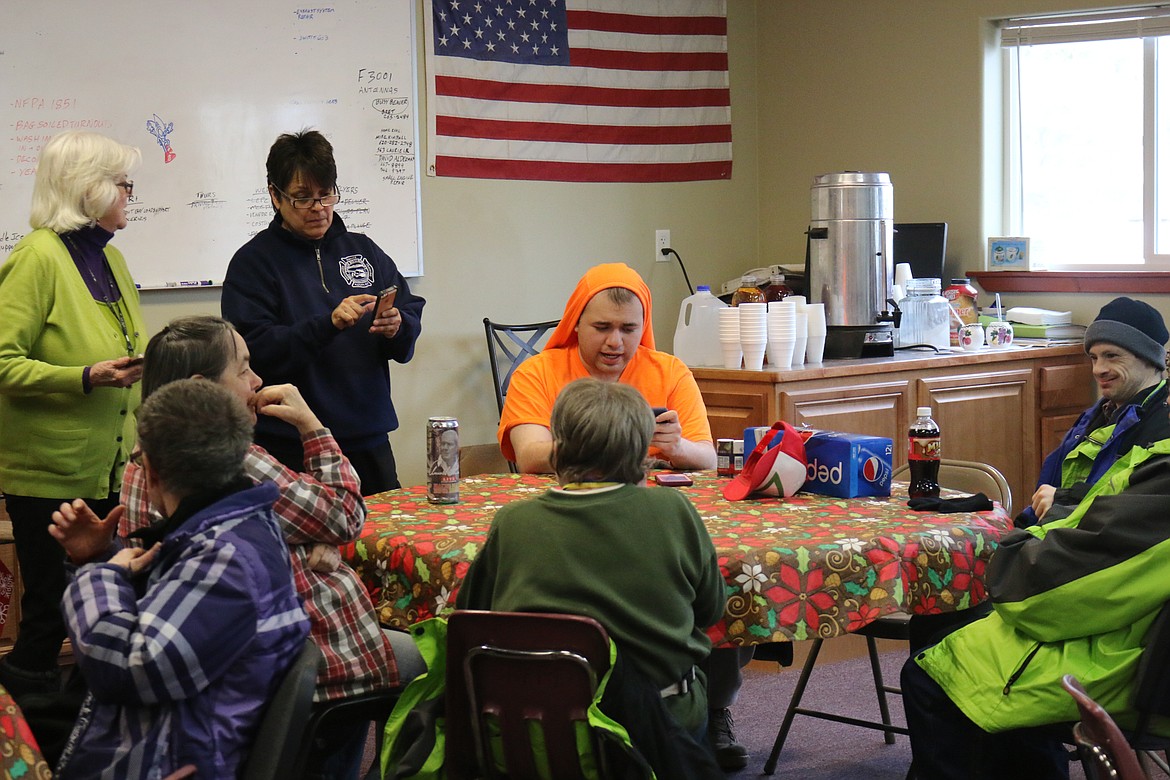 Photos by MANDI BATEMAN
Makana Zito Hashimoto, aka Kana, (in orange) visits with friends at Saturday&#146;s spaghetti feed. The event, hosted at South Boundary Fire Station No. 1 in Naples, will help fund the autistic young man&#146;s housing.