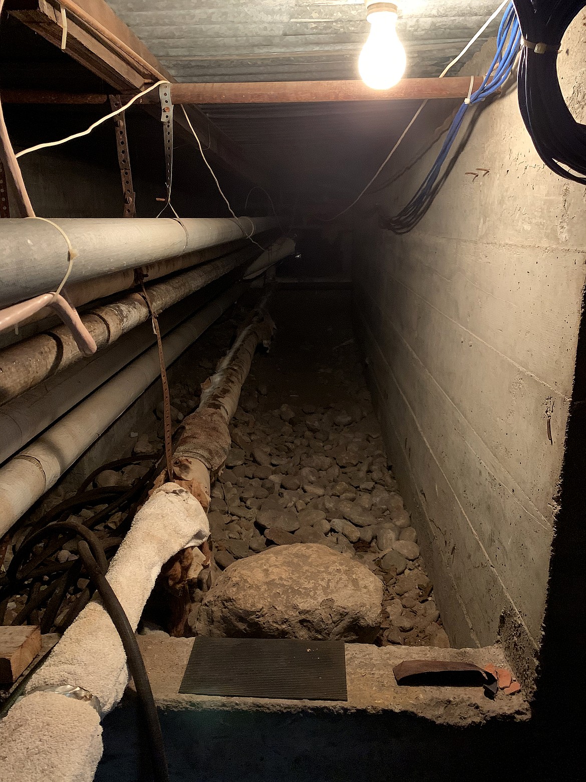 Service tunnels, such as this one, must be accessed to deal with any problem with the steam heating system at Glacier Gateway. Temperatures in the tunnels can reach 140 degrees and higher. (Jeremy Weber photo)