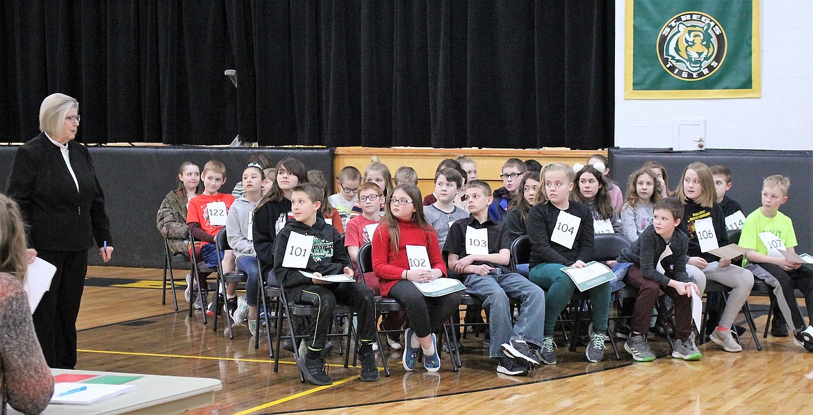 STUDENTS FROM Mineral County Schools competed on March 4 in the county spelling bee. Sharon Patterson, at left, helped organize the event and gave students instructions before the competition began in the St. Regis School gym. (Kathleen Woodford photos/Mineral Independent)