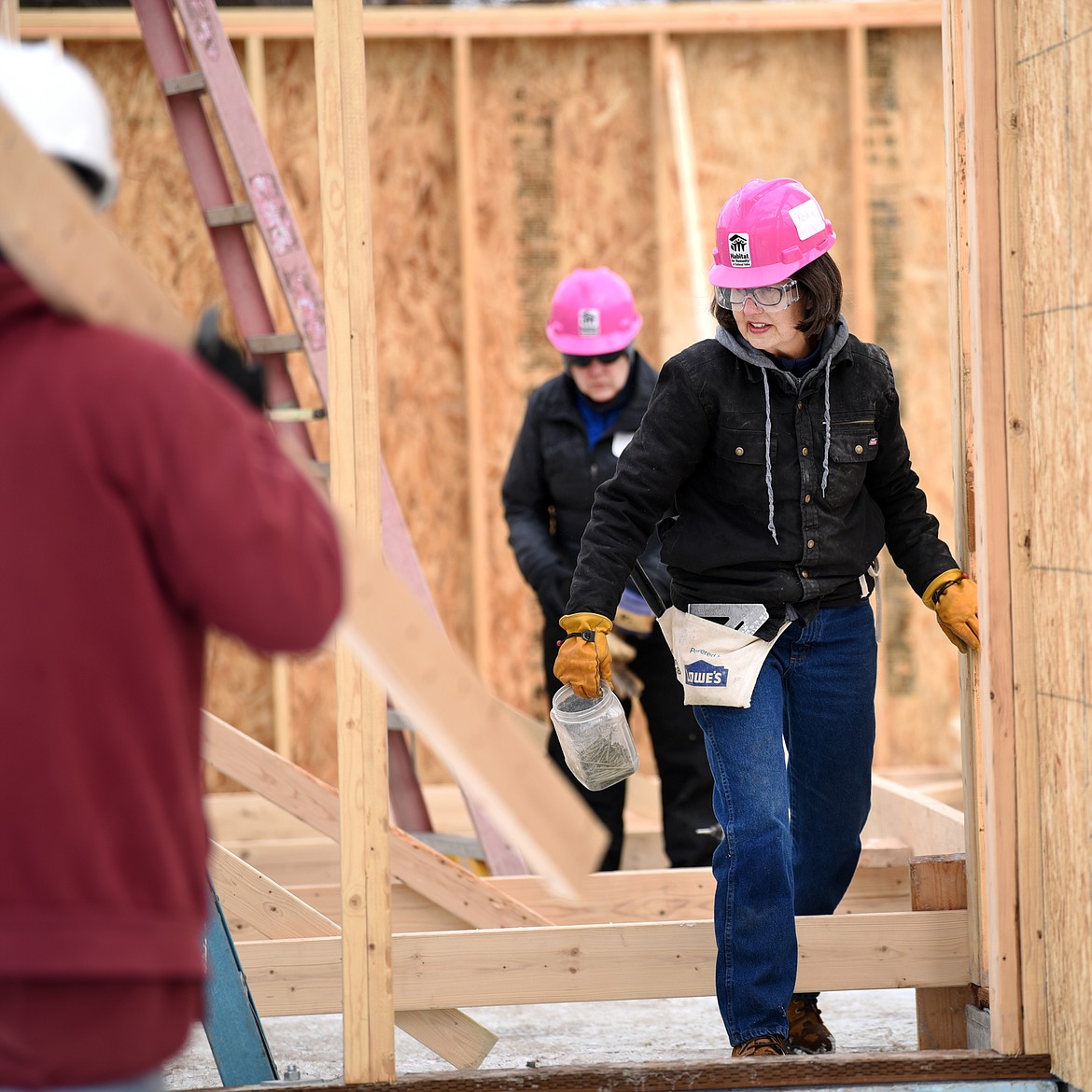 Robin Paone picks her way through the Habitat for Humanity construction site on Sixth Avenue West in Kalispell. Paone typically volunteers once a month with her husband, but she came out a day earlier this week because Friday was slated as the Women Build.