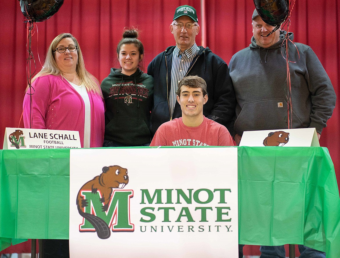 ARLEE SENIOR Lane Schall signs his Letter of Intent to play football for Minot State University of Minot, N.D. Flanking him are mother Jennifer, sister Sarah, father Scott and Arlee football head coach Chuck Forgey. (Photo courtesy of Logan Lefler)