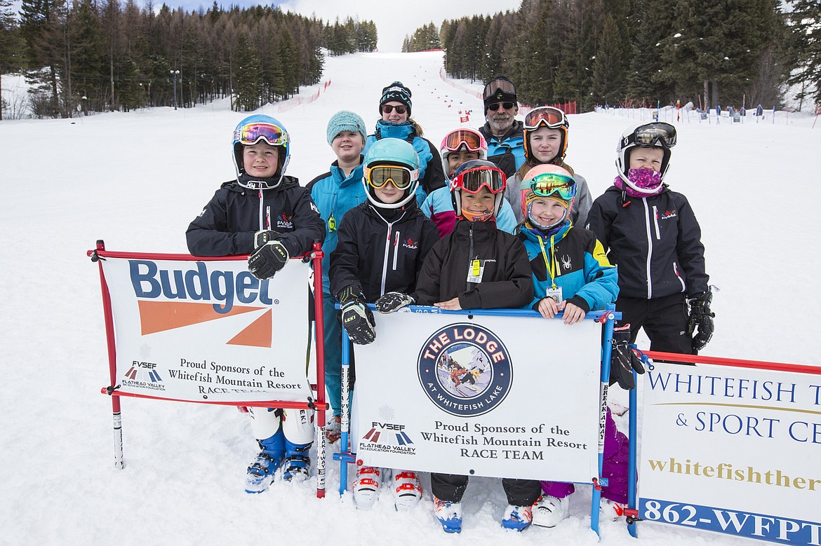 Skiers who will compete in the Northern Division Youth Ski League Championships in Big Sky, include from left, in the front, Katie Hersom, Kellie Klepper, Diego Bougard-Duncan and Kier Paatalo; middle, Rylan Veikle, Isla Bougard-Duncan, Melody McNally and Buren Brust; back,  Coach Madeline Williams and Coach Roy Lowman. (Photo courtesy Craig Moore/GlacierWorld.com)