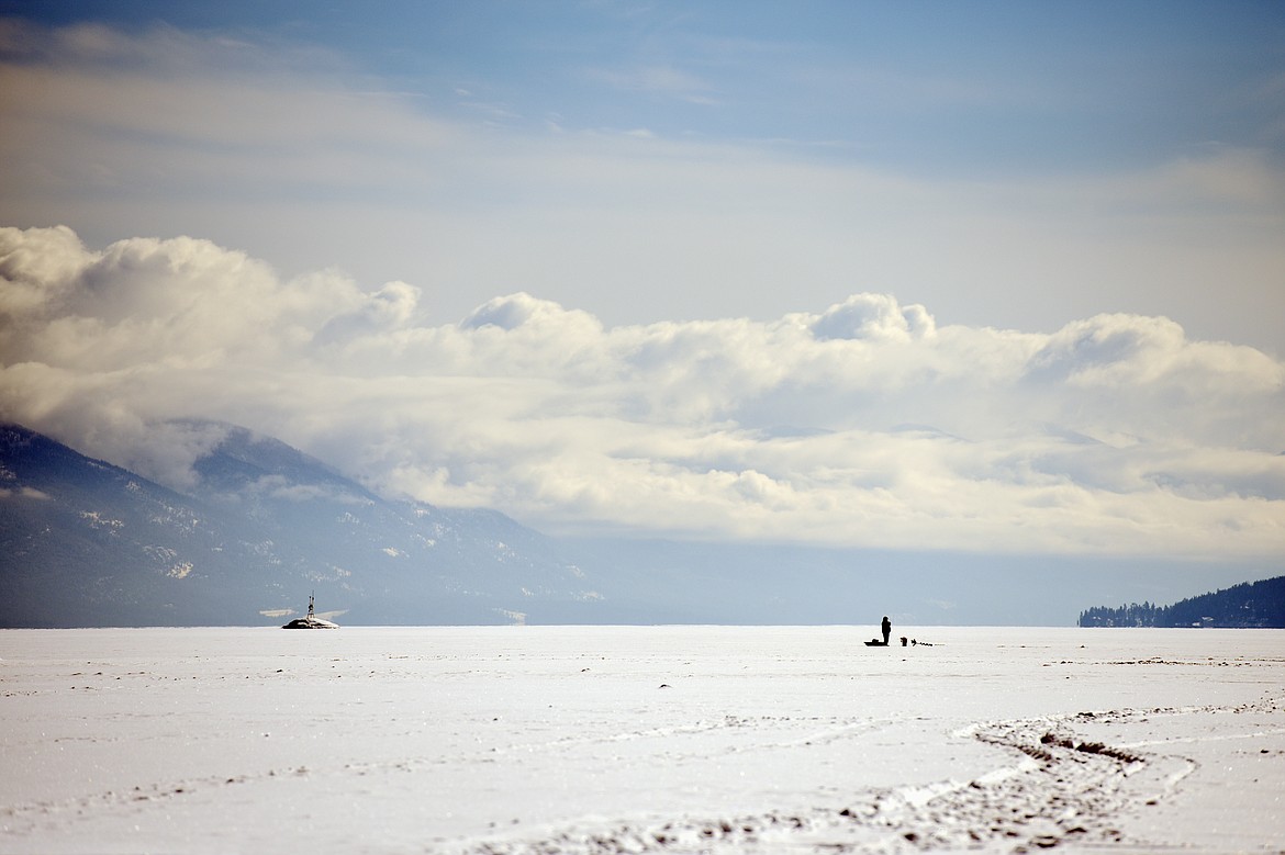 Michael Noland, of Kalispell, fishes on the frozen surface of Flathead Lake at Somers Bay on Feb. 20. (Casey Kreider/Daily Inter Lake)