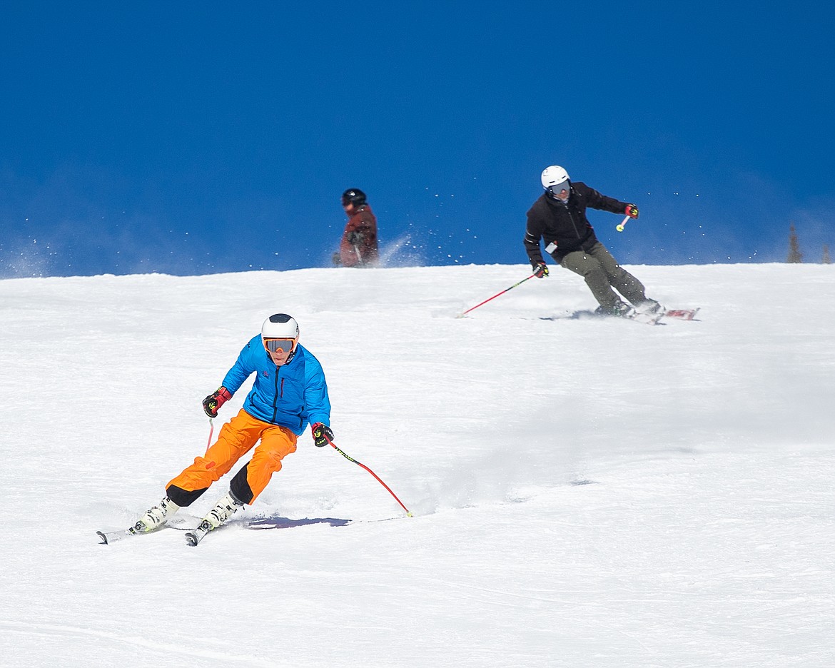 A pair of skiers carve down Ed's Run on Sunday at Whitefish Mountain Resort. (Daniel McKay/Whitefish Pilot)