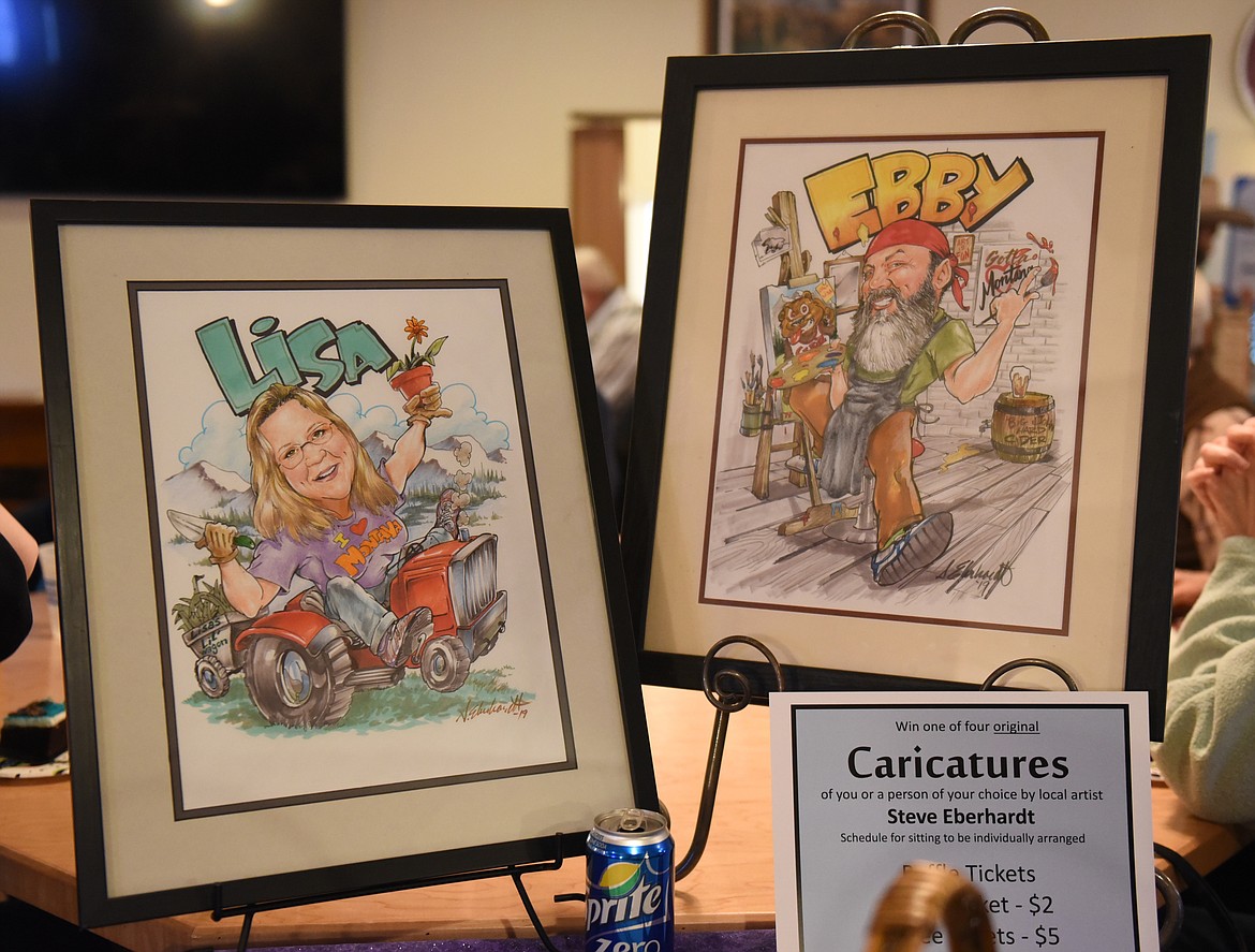 PORTRAIT CARICATURES by local artist Steve Eberhardt were raffled during the Bunkhouse Beans and Bacon event last Saturday night. Pictured are samples, which are caricuatures of Eberhardt and his wife, Lisa.