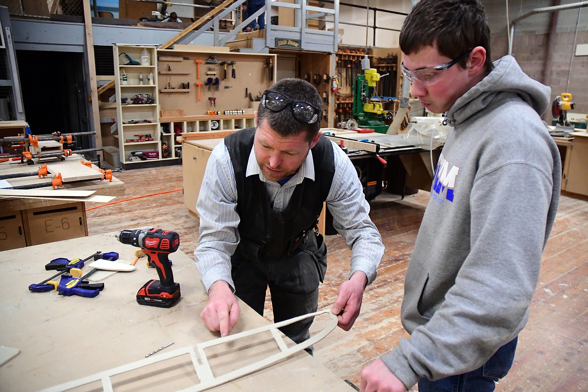 CFHS industrial arts teacher Jeff Remiker helps student Russell Albin with a project monday. The CFHS construction class will be building a cabins for Glacier National Park beginning next school year as part of the &quot;School to Park&quot; program. (Jeremy Weber photo)