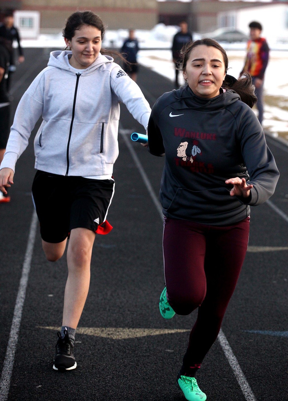 Rodney Harwood/Sun Tribune
Wahluke senior Mirna Gallaga (right) takes the handoff from Alondra Lozano during exchange work for the 4x100 relay. The Warriors host the Windbreaker Invitational on Friday.