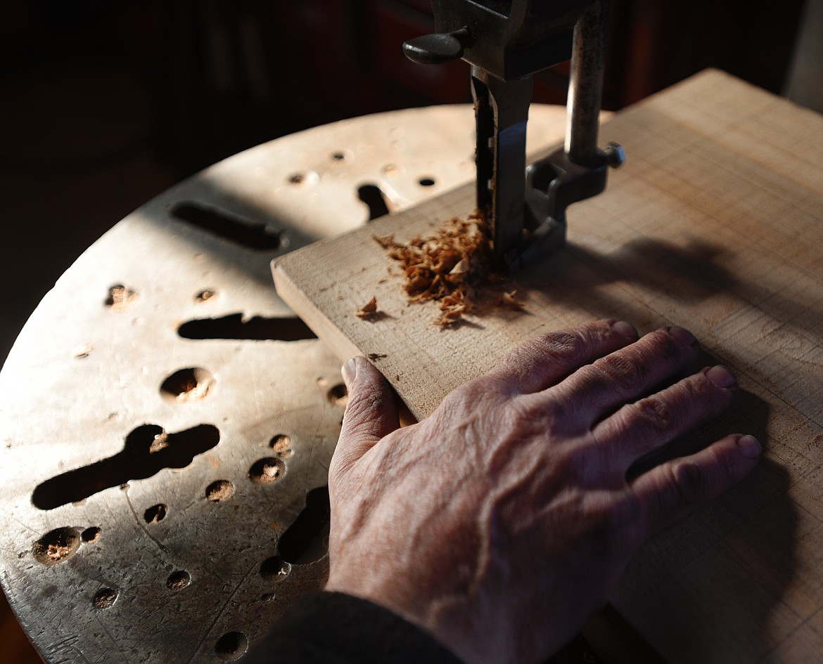 David Secrest drills holes into a piece of elm in his studio in Somers on Thursday, February 21.(Brenda Ahearn/Daily Inter Lake)