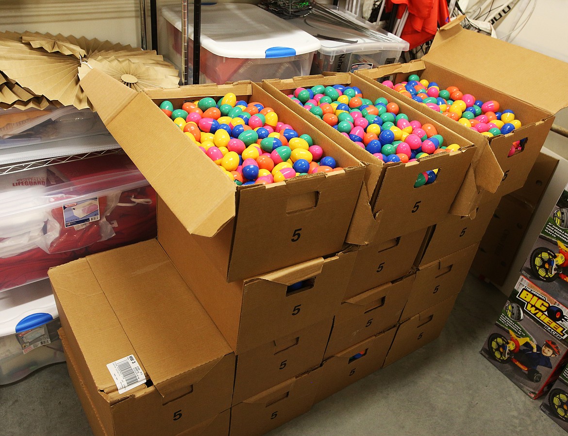 Post Falls city employees, volunteers, high school students and local businesses sponsors have filled around 8,000 eggs, as of Thursday, for this year's Post Falls Easter Egg Hunt Extravaganza on April 20 at Q'emiln Park. Around 16,000 plus eggs will be distributed at the hunt. (LOREN BENOIT/Press)