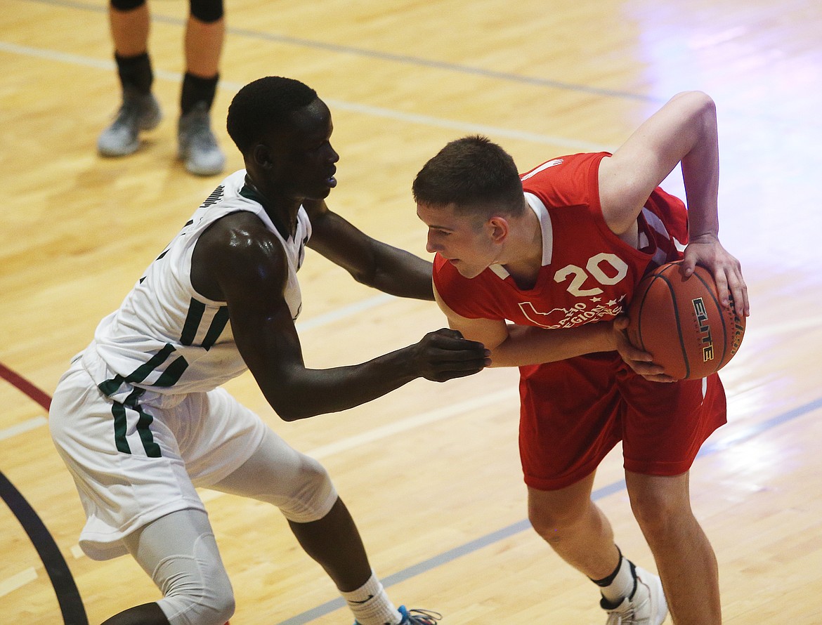 Region All-Star Gavven Desjarlais of Post Falls High looks to drive on Metro defender Amoro Lado of Vallivue in the 16th annual Idaho high school all-star basketball games Saturday at North Idaho College.