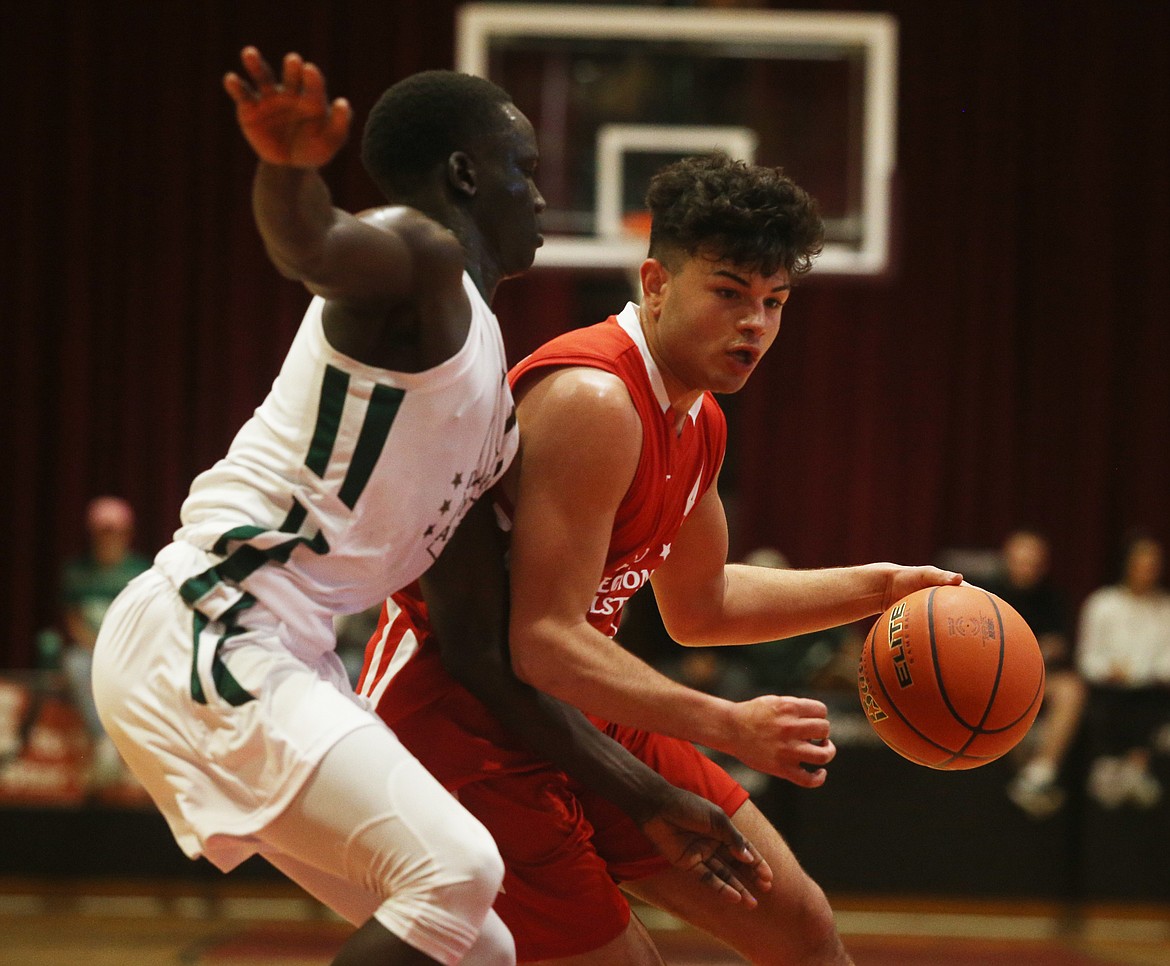 Region All-Star Donaven Santana drives toward the basket while defended by Metro All-Star Amoro Lado of Vallivue.