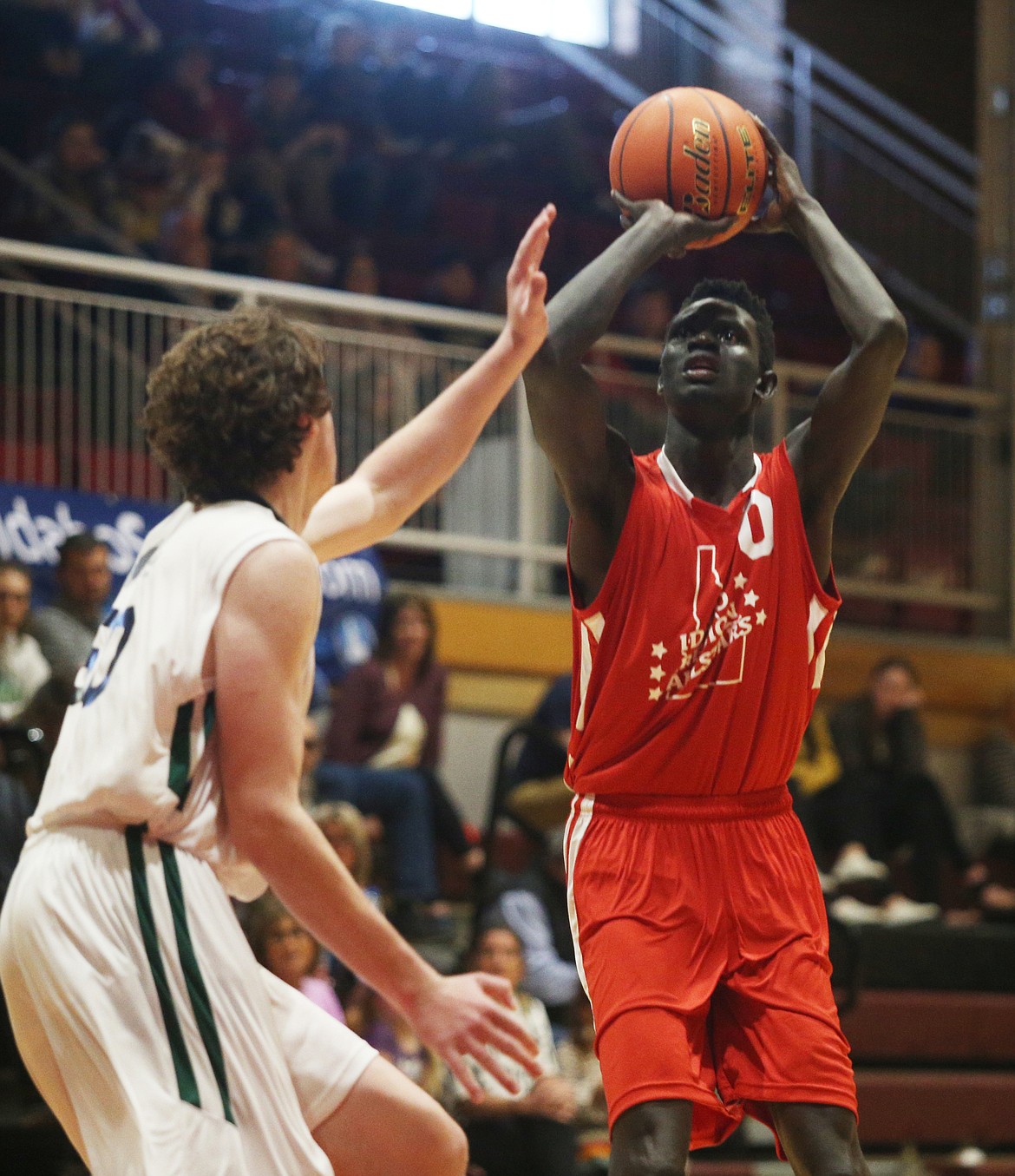 Region All-Star Kon Ajang of Genesis Prep shoots while defended by Mitchell Brizee of Twin Falls in the 16th annual Idaho high school all-star basketball games Saturday at North Idaho College.