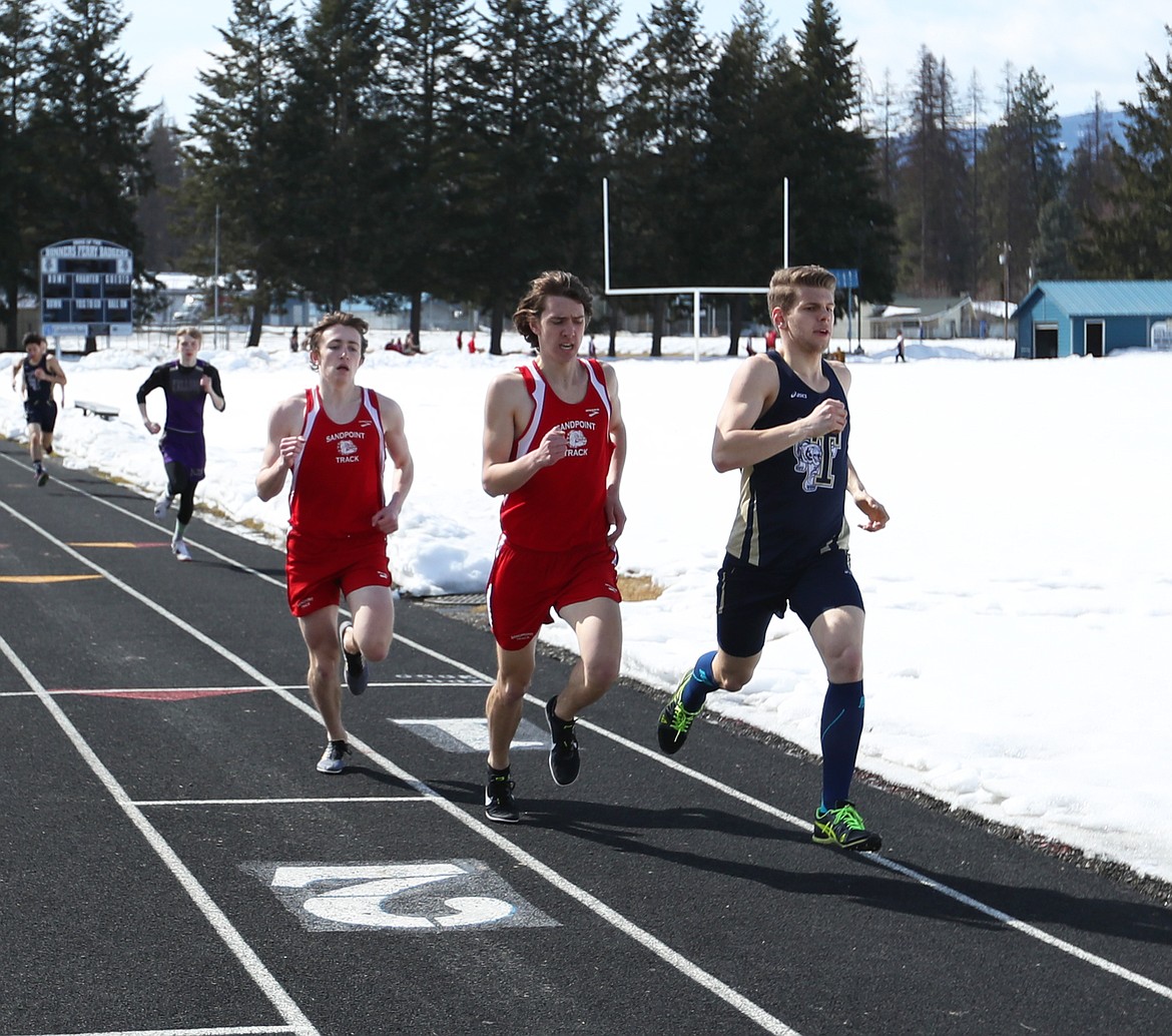 (Photo by KYLE CAJERO) Sandpoint&#146;s Seth Graham (left) and Sloan Woodward (center) pass a Timberlake runner during the first lap of the 800 meter dash on March 23.