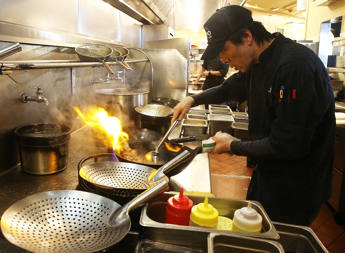 Executive chef Hyun Son prepares a dish for a customer at MoMo Sushi.Wok.Grill on Thursday. The Food Network contacted the restaurant in December to highlight them on a family food relay showdown. The show airs Monday at 10 p.m. (LOREN BENOIT/Press)