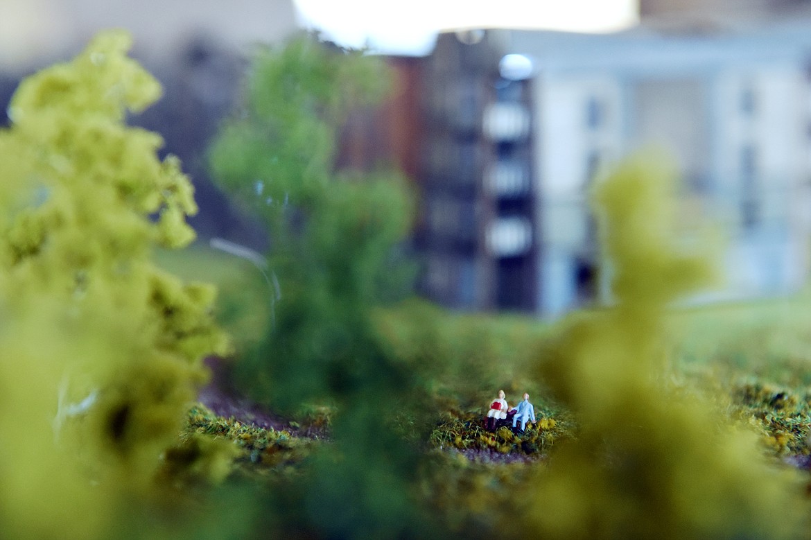 Miniature figurines sit on a bench along a walking path on an architectural model of The Woodlands, a residential community for adults 55 and up, displayed in the company&#146;s office in Kalispell on Wednesday, March 20. (Casey Kreider/Daily Inter Lake)