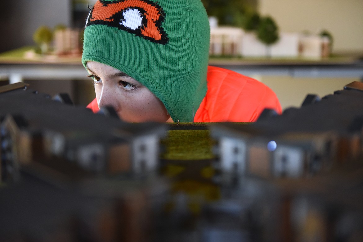 Stillwater Christian School freshman Jeremiah Jepson inspects an architectural model of The Woodlands.