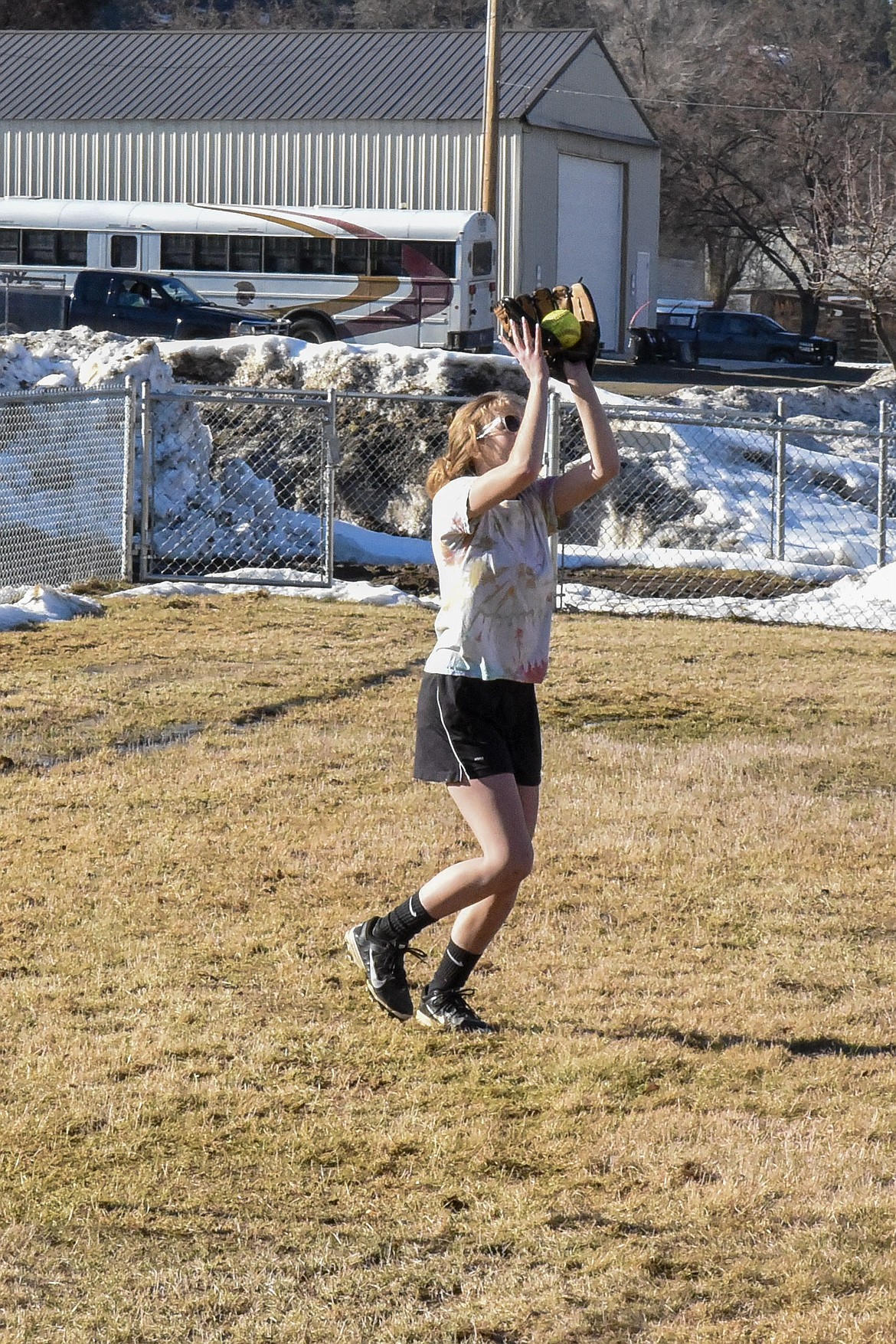 Troy senior Annie Day makes a catch during fielding practice at the Troy practice field March 18. (Ben Kibbey/The Western News)