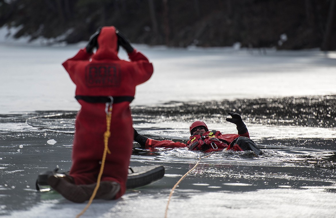 Stephanie Anderson, left, practices her rescuing skills by pulling Terry Crooks out of Throop Lake at a seasonal rescue training exercise for David Thompson Search and Rescue crew members, Saturday at Throop Lake. (Luke Hollister/The Western News)