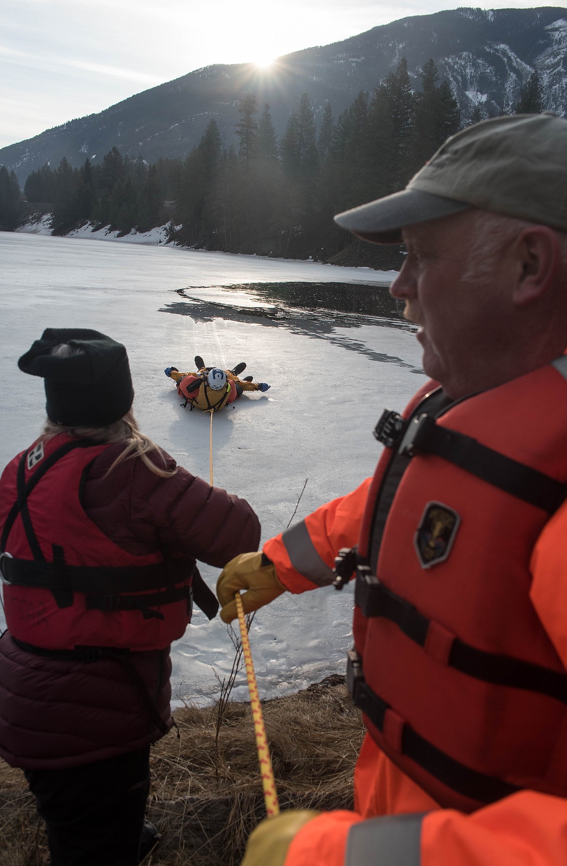 Susan Lippert, left, and David Nitschke, right, help Norm Branch rescue John Obst at a seasonal rescue training exercise for David Thompson Search and Rescue crew members, Saturday at Throop Lake. (Luke Hollister/The Western News)