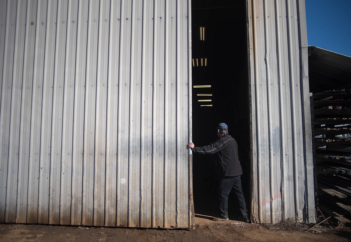 LeRoy Thom, opens the door to his machine shop, Friday at Montana Machine & Fabrication. The shop works on whatever comes in the door, he said. (Luke Hollister/The Western News)