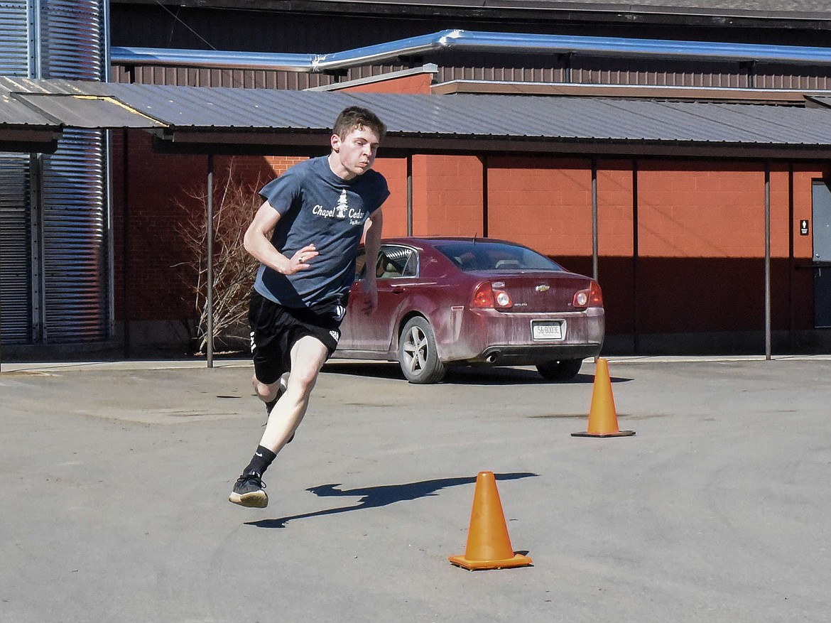 Troy senior Hunter Leighty Sprints out a short course in the back parking lot at Troy High School during practice March 22. (Ben Kibbey/The Western News)