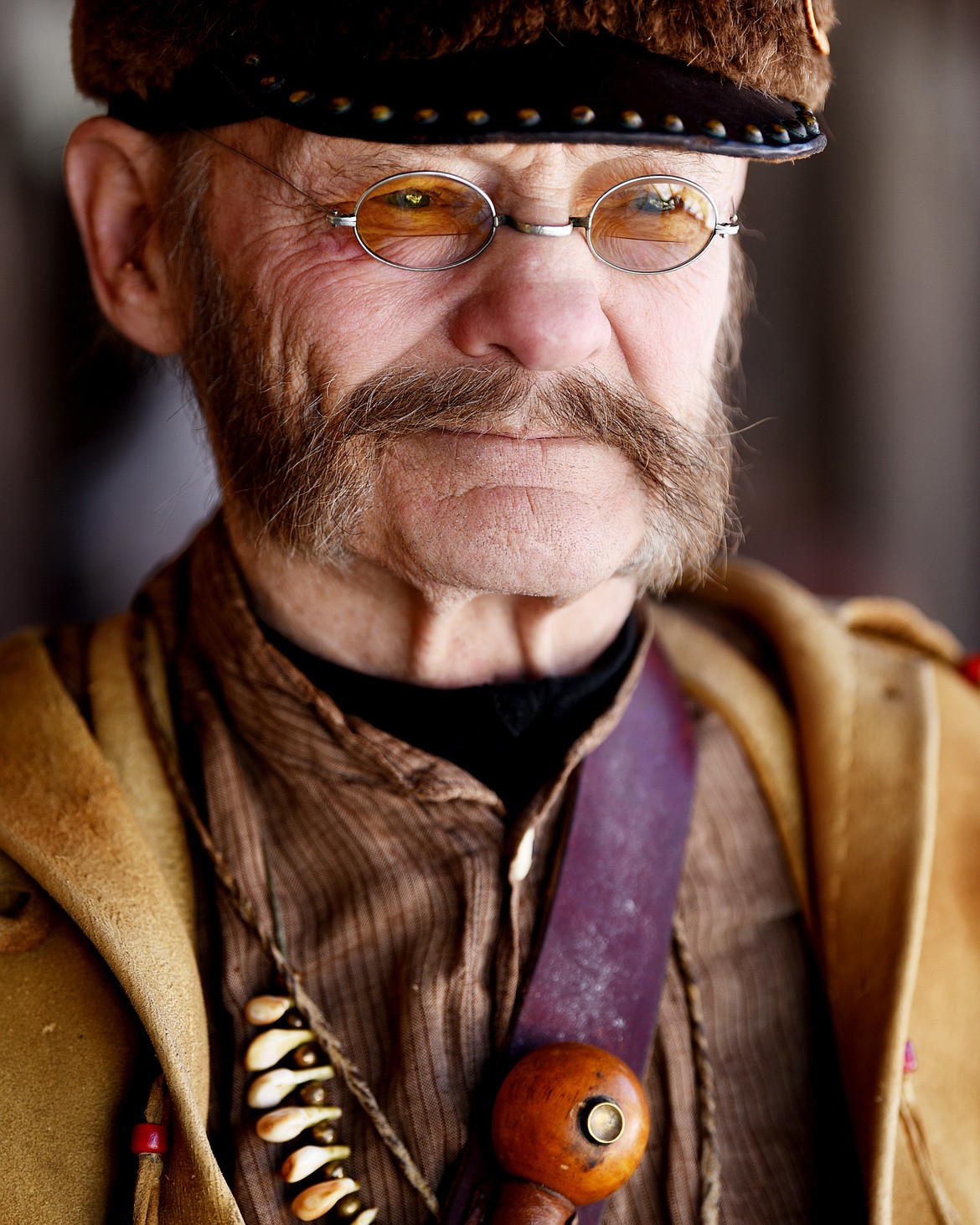 Stu Sorensen outside the Bad Rock Settlement Museum on Monday near Columbia Falls. Sorensen is wearing a buckskin outfit and beaver skin hat he had custom-made from hides he trapped or shot.
