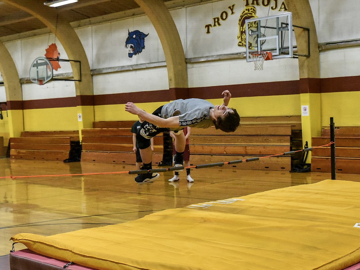 Troy junior Ricki Fisher easily clears the &quot;bar&quot; at an initially low height during practice March 22. (Ben Kibbey/The Western News)