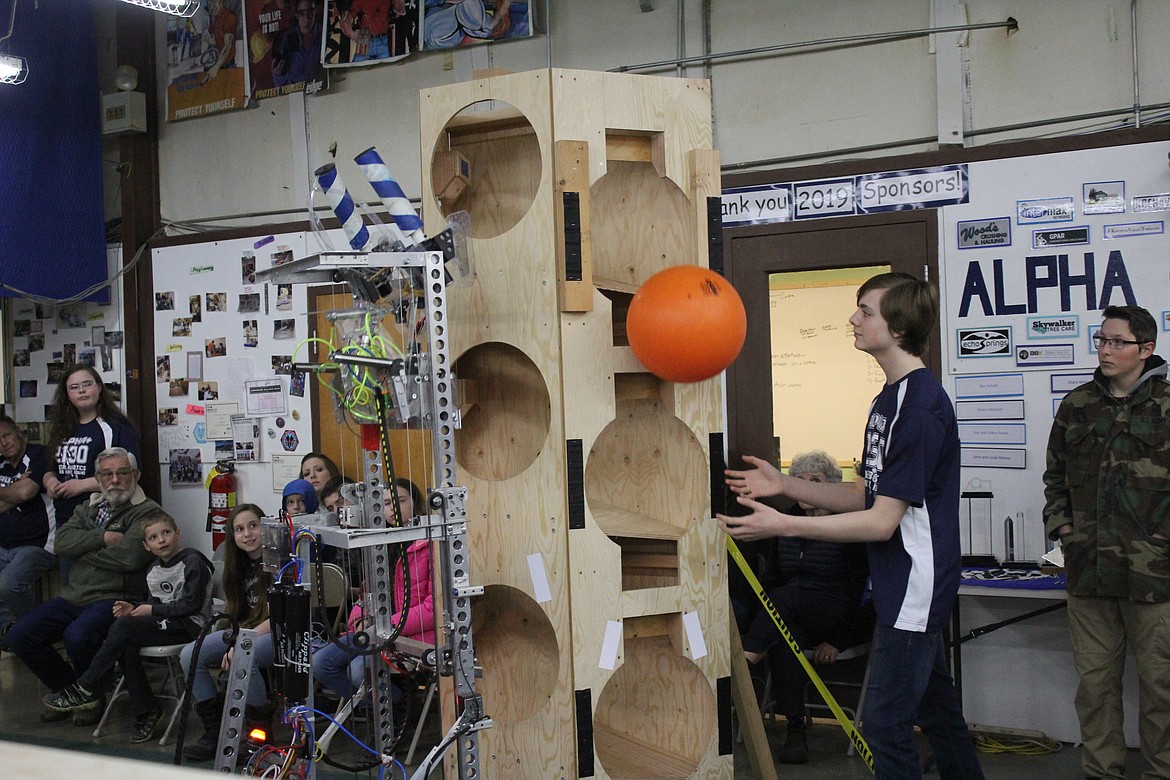 Photos by TANNA YEOUMANS
FIRST Team 2130 Alpha+ demonstrates how its robot could pick up and dispense a ball into the rocket during a public presentation on Saturday.