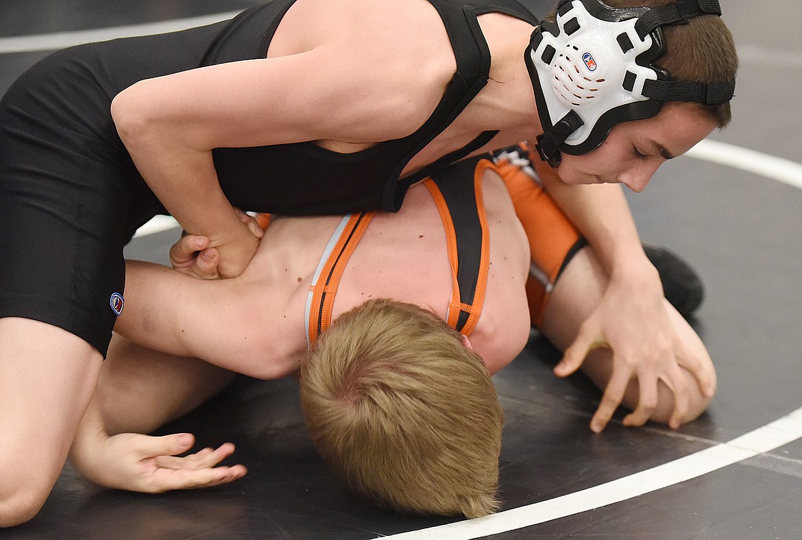 DREW CAREY of Plains/Hot Springs works for points against Gabe Mobley of Frenchtown in the Middle 100 third-place match. Carey won the match in a 6-5 decision.