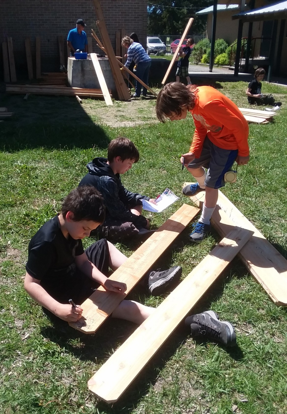 (Courtesy Photo)
Writing names on the back of the boards after they were cut to each students height.