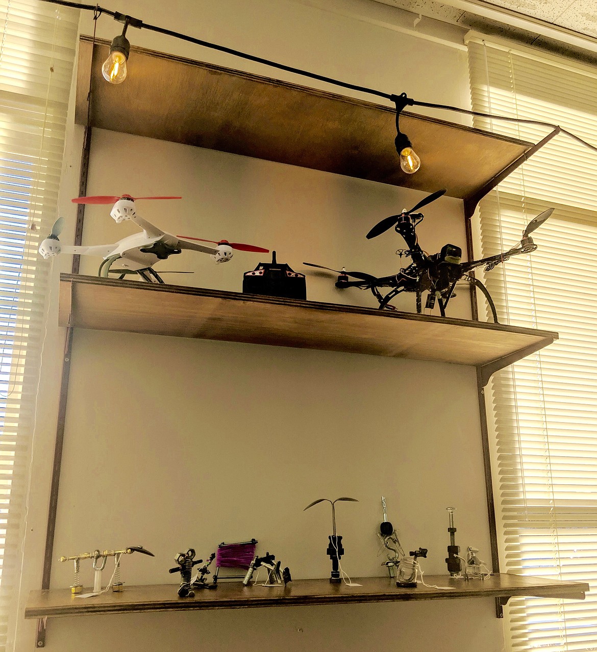 &#147;Bolt bots&#148; created by the students and drones sit on a shelf near the back part of the room.