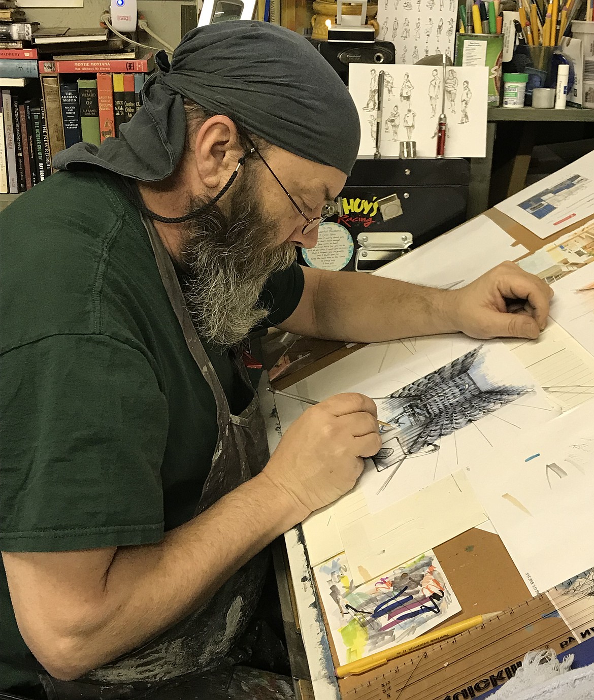 STEVE EBERHARDT works in his studio on a sketch for a large project to which his son, Billy, has undertaken back East. Steve, who lives with his wife Lisa east of Paradise, has 45 years of professional artistic experience. (Photo courtesy of Lisa Eberhardt)