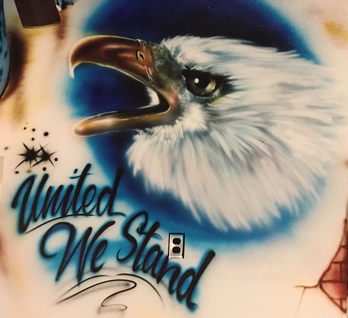 EBERHARDT USED his airbrush technique to design the eagle above for the walls of Chuy&#146;s restaurant chain outlets in California, and the design below for the Clark Fork Valley Cafeteria in Plains.