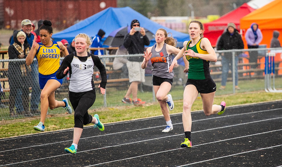 Lauren Schulz races through rain in the 100 meter dash Saturday at the Columbia Falls Invitational.