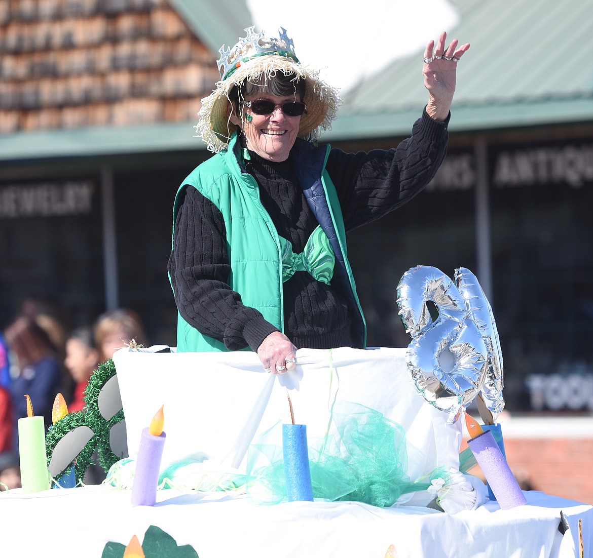 CARLENE BOCKMAN waves to the crowd while aboard the O&#146;Leary&#146;s Old Ladies float in the TRIC St. Patrick&#146;s Day Parade last Sunday in Ronan.