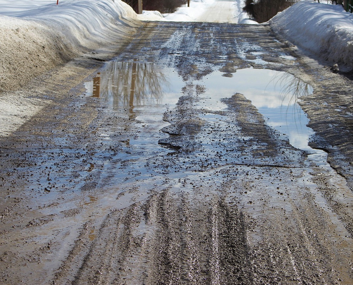 Mineral County drivers contend with muddy roads and pot holes as snow begins to melt with temperatures rising into the 30s and 40s. (Kathleen Woodford/Mineral Independent).