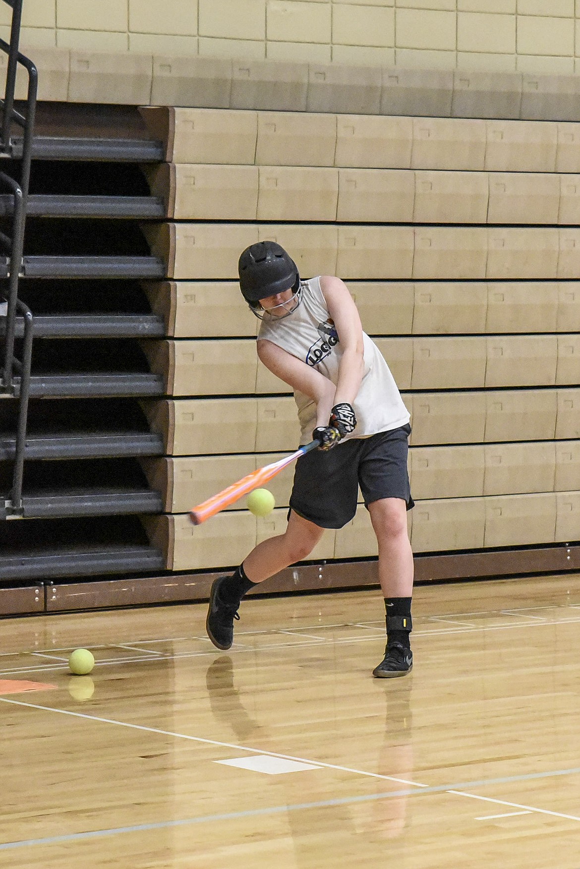 Libby sophomore makes contact during indoor softball practice in the Ralph Tate Memorial Gym Tuesday. (Ben Kibbey/The Western News)