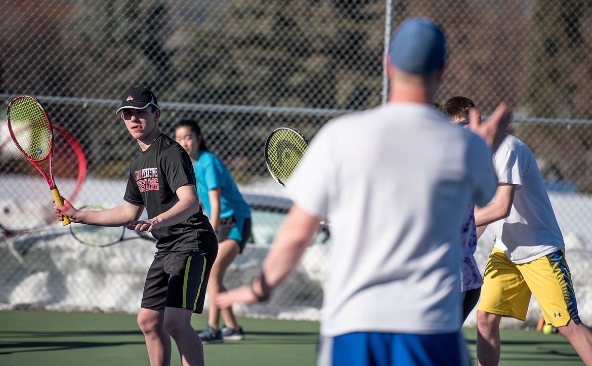 Trey Thompson, left, practices hitting forehand while getting advice from his Libby Head Coach Kyle Hannah, Wednesday. (Luke Hollister/The Western News)