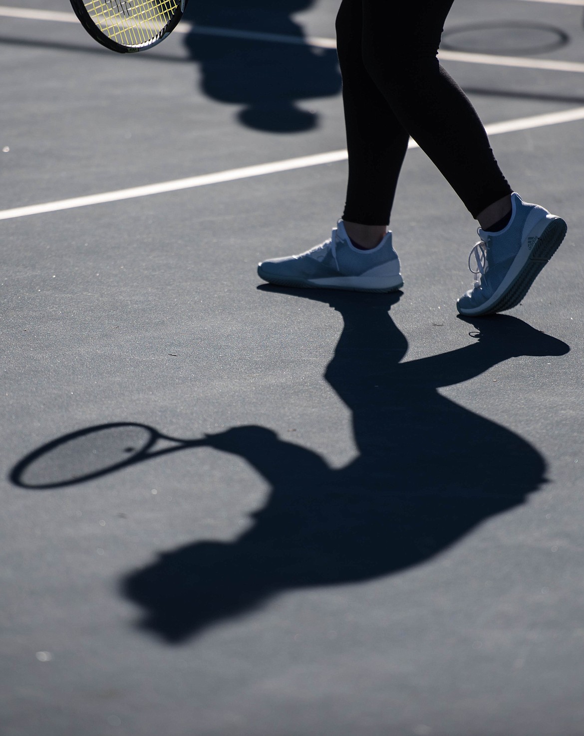 Libby High School students practice tennis outside in the afternoon sun, Wednesday at the local tennis courts.