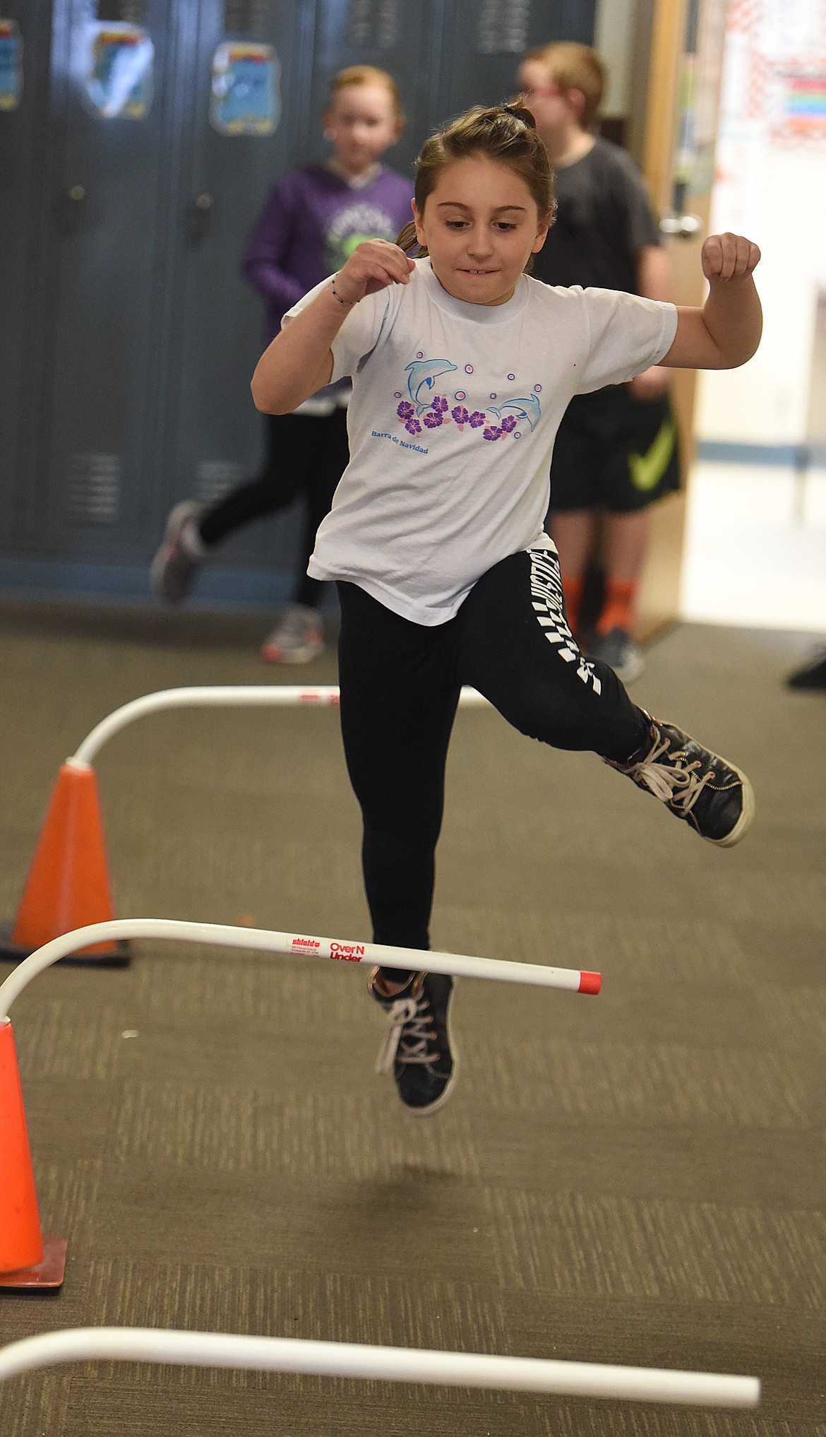 ANNISTON FLYNN jumps over hurdles during a physical fitness activity in conjuction with the Kids Heart Challenge last week at Linderman Elementary School.