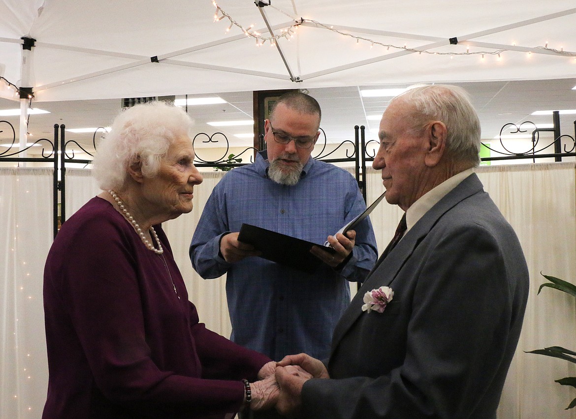 (Photo by CAROLINE LOBSINGER)
Doris and Glenn Hescock gaze into each other&#146;s eyes as the officiant reads their vows during the couple&#146;s marriage ceremony Thursday at Sandpoint Furniture in Ponderay. The couple had visited the store looking for furniture the week before and a conversation about their upcoming wedding led the store to offer to host the ceremony.