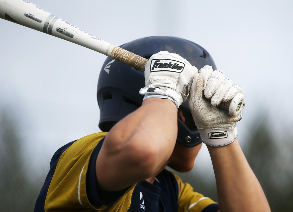 A Timberlake High baseball player studies the opposing pitcher from inside the on-deck circle in a game against Lakeland.