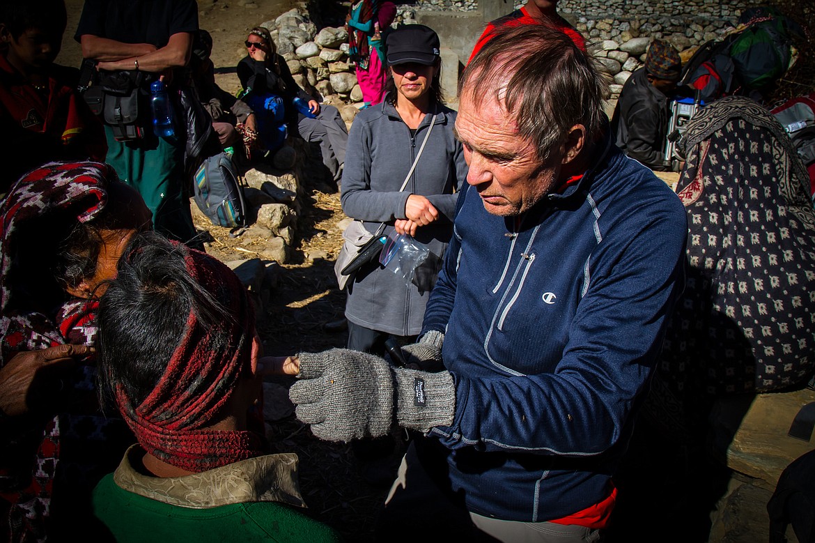 Mike Szymanski inspects a local villages ear on a past trip to the village of Muri in Nepal.