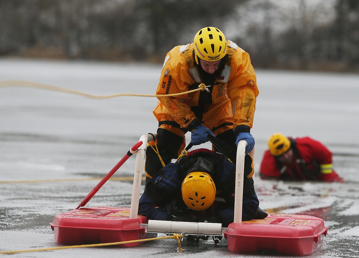 Northern Lakes firefighter Dan Schaefer rescues a member of the Kootenai County Sheriff&#146;s Office Rescue Dive Team during an ice rescue training at Avondale Lake earlier this year. (LOREN BENOIT/Press File)